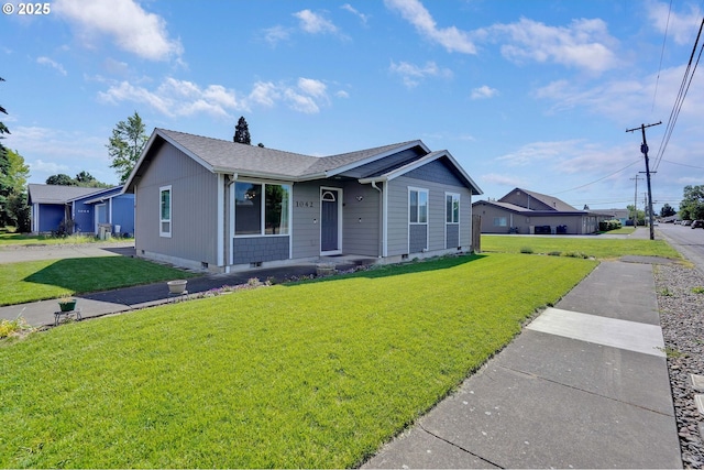 single story home with a front lawn, crawl space, and a shingled roof