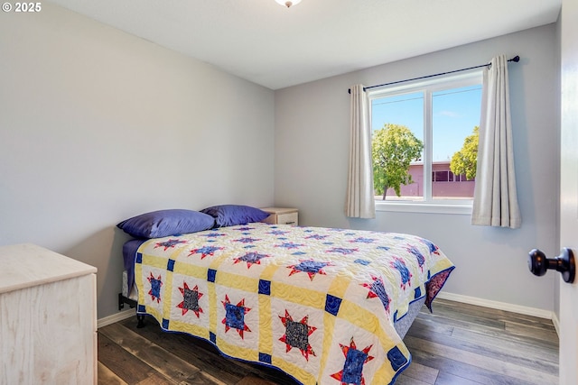 bedroom featuring baseboards and wood finished floors