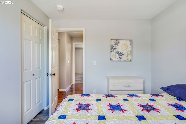 bedroom with dark wood-style flooring