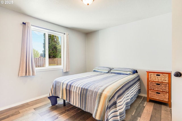 bedroom featuring hardwood / wood-style floors and baseboards