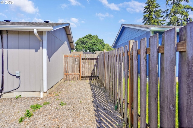 view of yard featuring fence and a gate