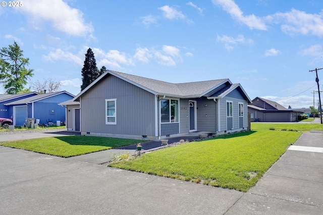 ranch-style home with a front yard, driveway, crawl space, and roof with shingles