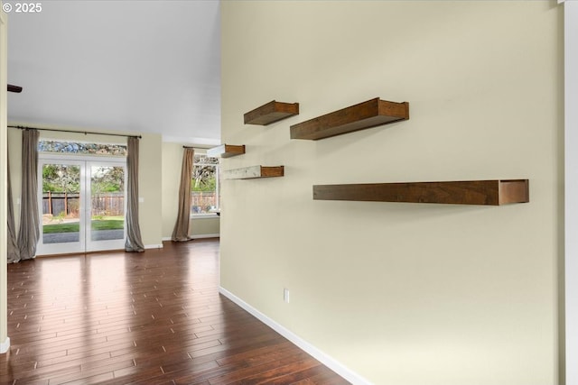interior space featuring dark wood-type flooring and baseboards