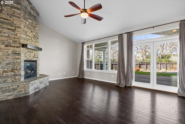unfurnished living room with ceiling fan, high vaulted ceiling, a fireplace, wood finished floors, and baseboards