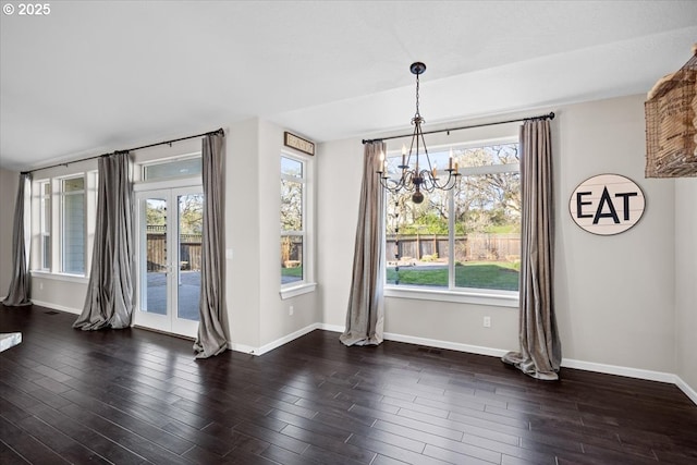 unfurnished dining area featuring visible vents, baseboards, a chandelier, and dark wood finished floors
