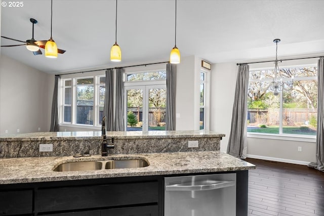 kitchen with stainless steel dishwasher, baseboards, a sink, and a healthy amount of sunlight