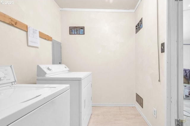10105 NE 59th St, Vancouver, WA 98662 - washroom with independent washer and dryer, crown molding, light wood-style flooring, and baseboards