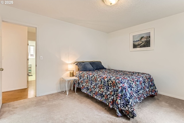 bedroom featuring carpet floors and a textured ceiling