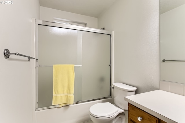 bathroom featuring enclosed tub / shower combo and toilet