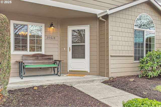 view of exterior entry featuring a porch