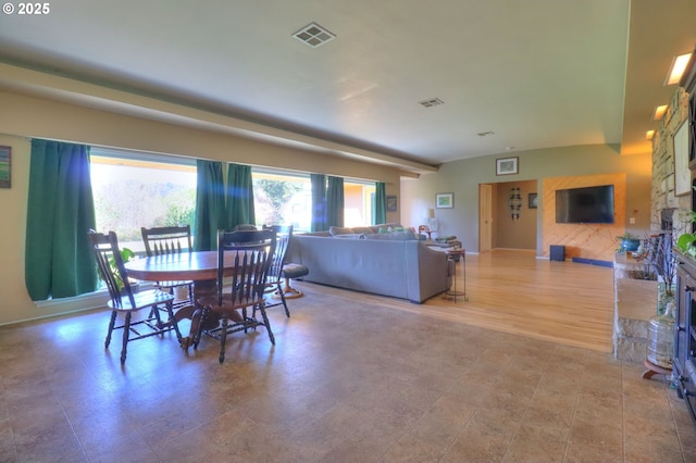 dining space with a fireplace and visible vents