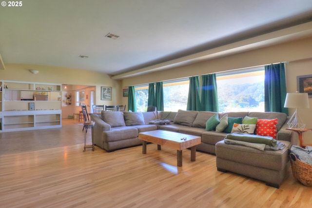 living room featuring visible vents and light wood-style floors