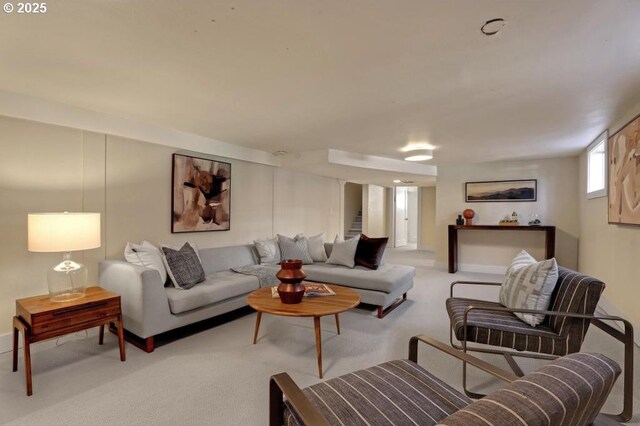 living room featuring stairway and carpet