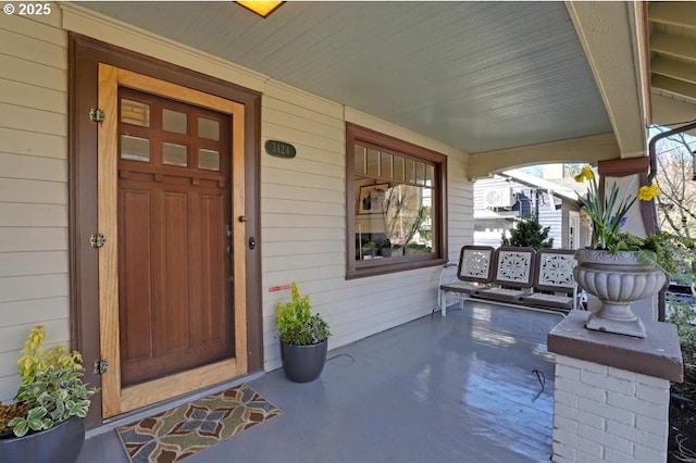 view of exterior entry with covered porch