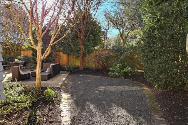 view of yard featuring a patio, fence, and an outdoor hangout area