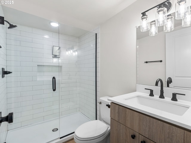 bathroom with vanity, toilet, and an enclosed shower