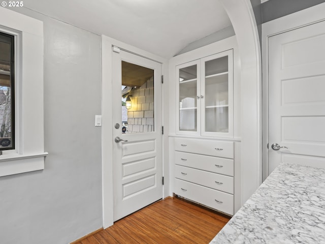 entryway featuring vaulted ceiling and wood-type flooring