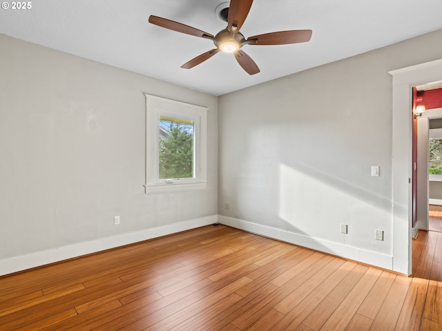 empty room with hardwood / wood-style floors and ceiling fan