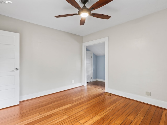 empty room with ceiling fan and light hardwood / wood-style flooring