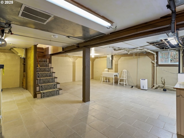 basement featuring light tile patterned flooring