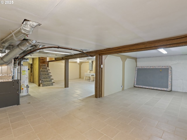 basement with light tile patterned floors and gas water heater