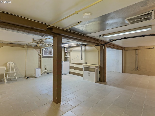 basement featuring washer / clothes dryer and light tile patterned floors