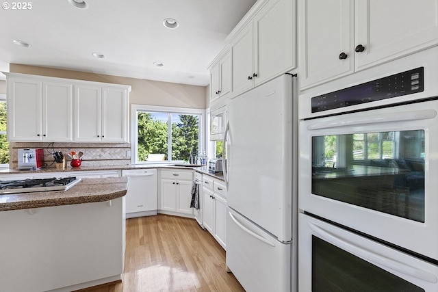 1221 SW Forest Meadows Way, Lake Oswego, OR 97034 - kitchen featuring white appliances, white cabinetry, light wood-style flooring, recessed lighting, and tasteful backsplash