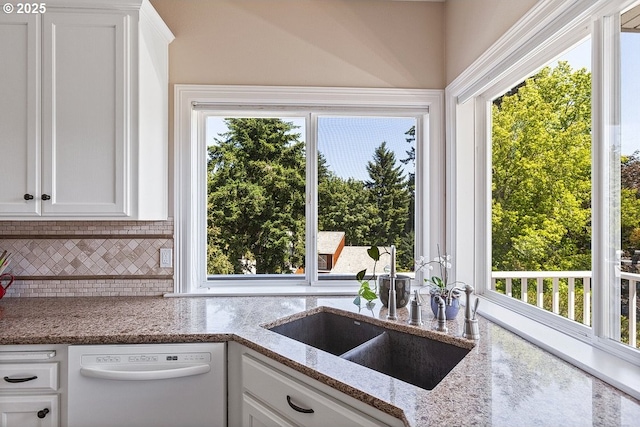 1221 SW Forest Meadows Way, Lake Oswego, OR 97034 - kitchen featuring white dishwasher, healthy amount of natural light, tasteful backsplash, and white cabinetry