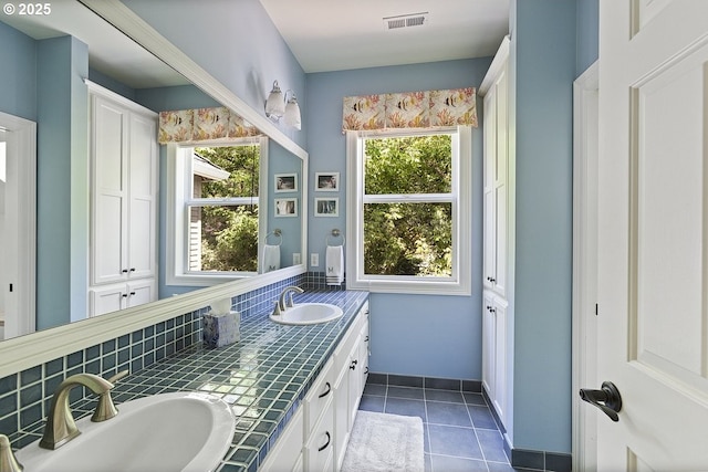 1221 SW Forest Meadows Way, Lake Oswego, OR 97034 - bathroom featuring double vanity, tile patterned floors, and decorative backsplash