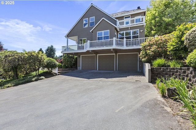 1221 SW Forest Meadows Way, Lake Oswego, OR 97034 - view of front of house with concrete driveway, an attached garage, and a balcony