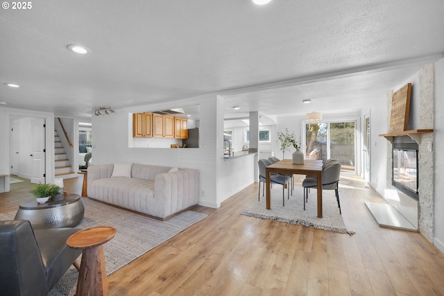 living room featuring a textured ceiling and light wood-type flooring