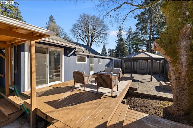 wooden deck with an outdoor living space, a gazebo, and a patio