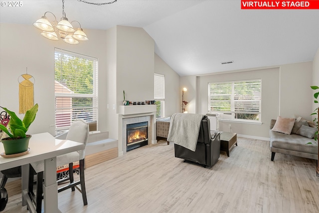 15707 NE Beech St, Portland, OR 97230 - living area with light wood finished floors, a chandelier, lofted ceiling, and a tile fireplace