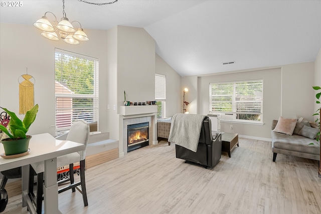 15707 NE Beech St, Portland, OR 97230 - living area with light wood finished floors, a chandelier, vaulted ceiling, and a fireplace