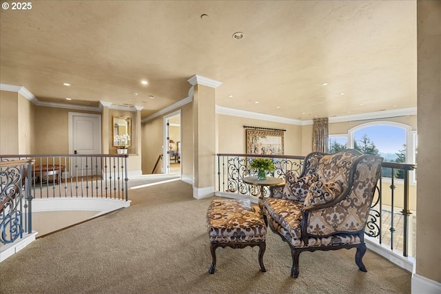 sitting room featuring crown molding and carpet flooring