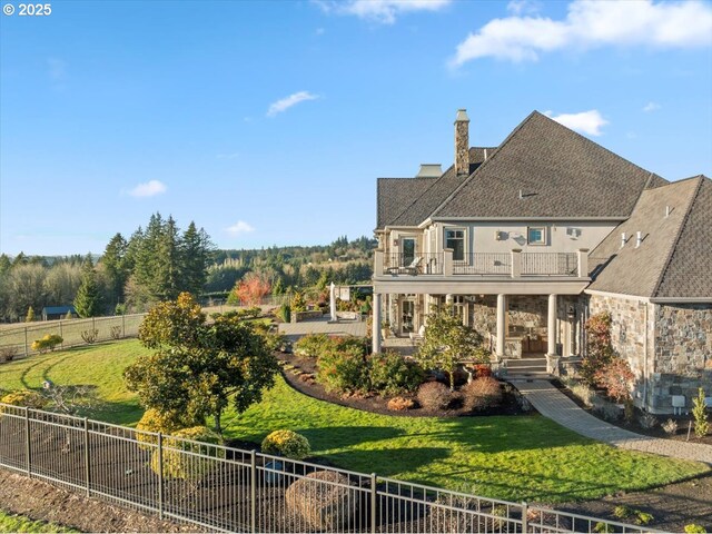 12955 NW Skyline Blvd, Portland, OR 97231 - back of property featuring a balcony, a chimney, covered porch, and stone siding