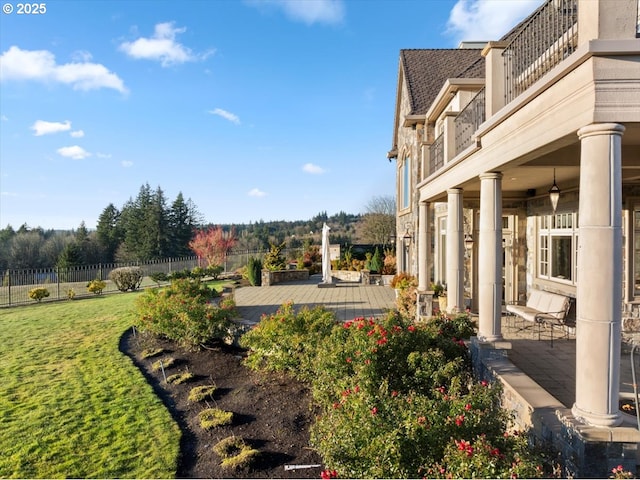 view of yard with a balcony and a patio area