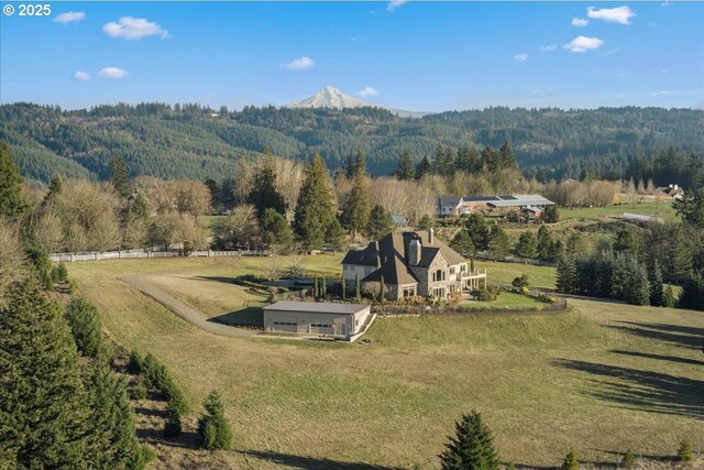 12955 NW Skyline Blvd, Portland, OR 97231 - view of side of home featuring stone siding, a vegetable garden, a chimney, and fence