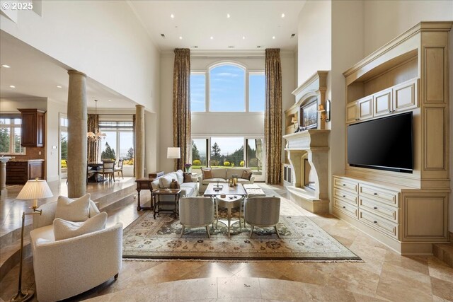 12955 NW Skyline Blvd, Portland, OR 97231 - living room with ornate columns, a high ceiling, plenty of natural light, recessed lighting, and a fireplace with raised hearth