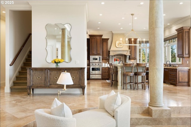 12955 NW Skyline Blvd, Portland, OR 97231 - living room with decorative columns, crown molding, light marble finish flooring, recessed lighting, and stairs