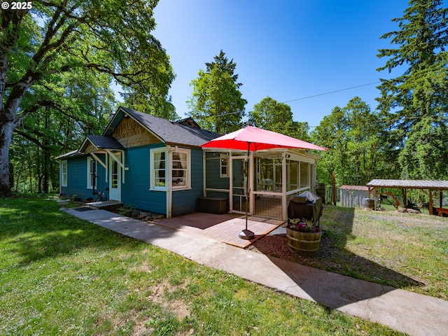 rear view of property with a yard