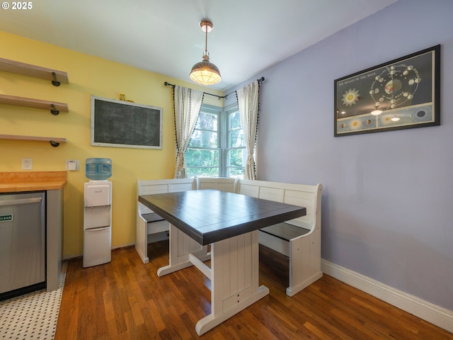 dining room with baseboards and wood finished floors