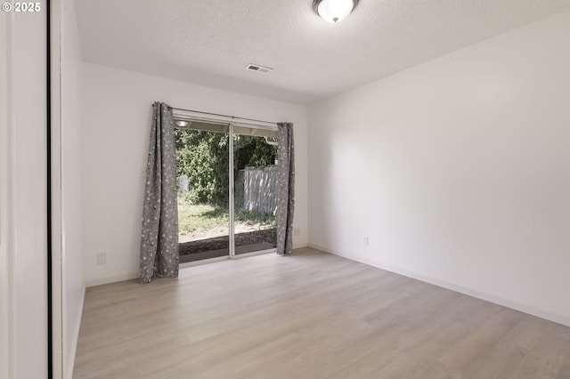 6139 SE 103rd Ave, Portland, OR 97266 - empty room with light wood-style flooring and a textured ceiling
