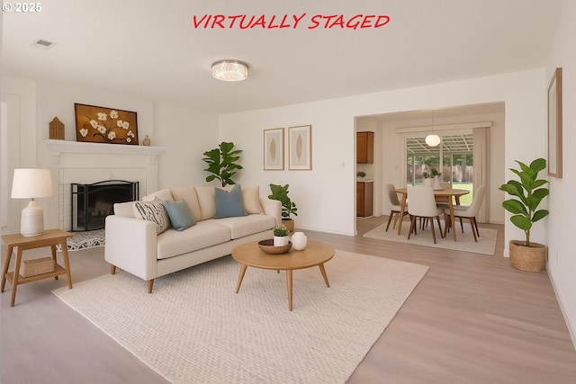 6139 SE 103rd Ave, Portland, OR 97266 - living area with a fireplace and light wood-style floors
