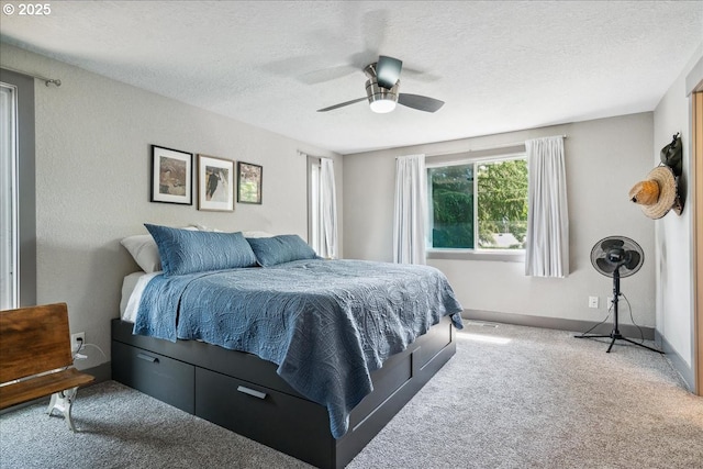 carpeted bedroom with a textured ceiling and a ceiling fan