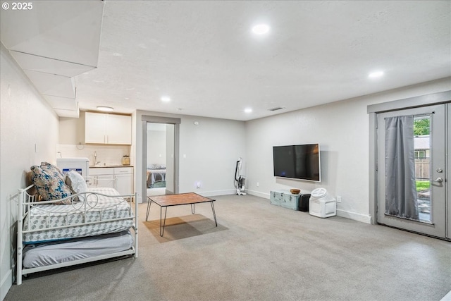living area with recessed lighting, light colored carpet, and baseboards