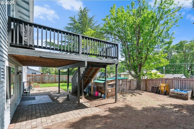 view of patio with a fenced backyard, stairway, and a wooden deck