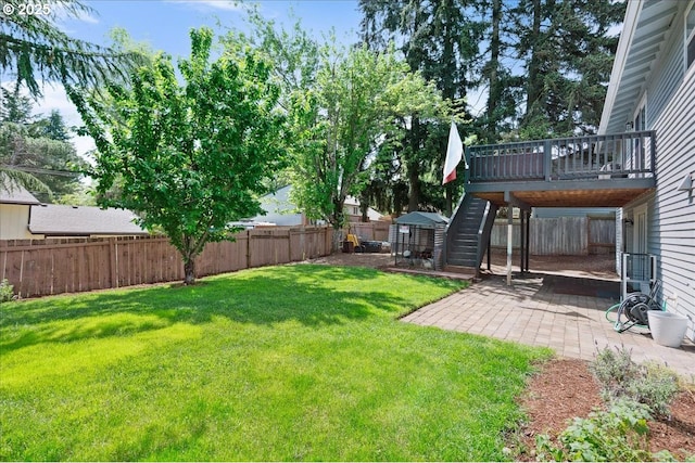 view of yard featuring a patio area and a wooden deck