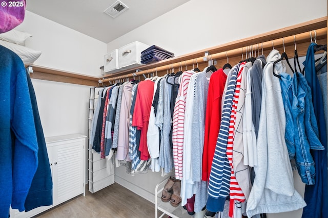 walk in closet featuring visible vents and wood finished floors