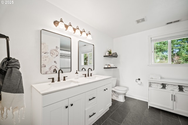 full bathroom with a healthy amount of sunlight, visible vents, and a sink